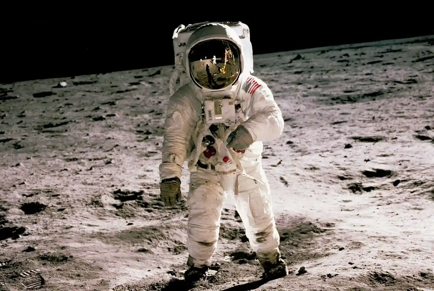 astronaut standing on gray sand